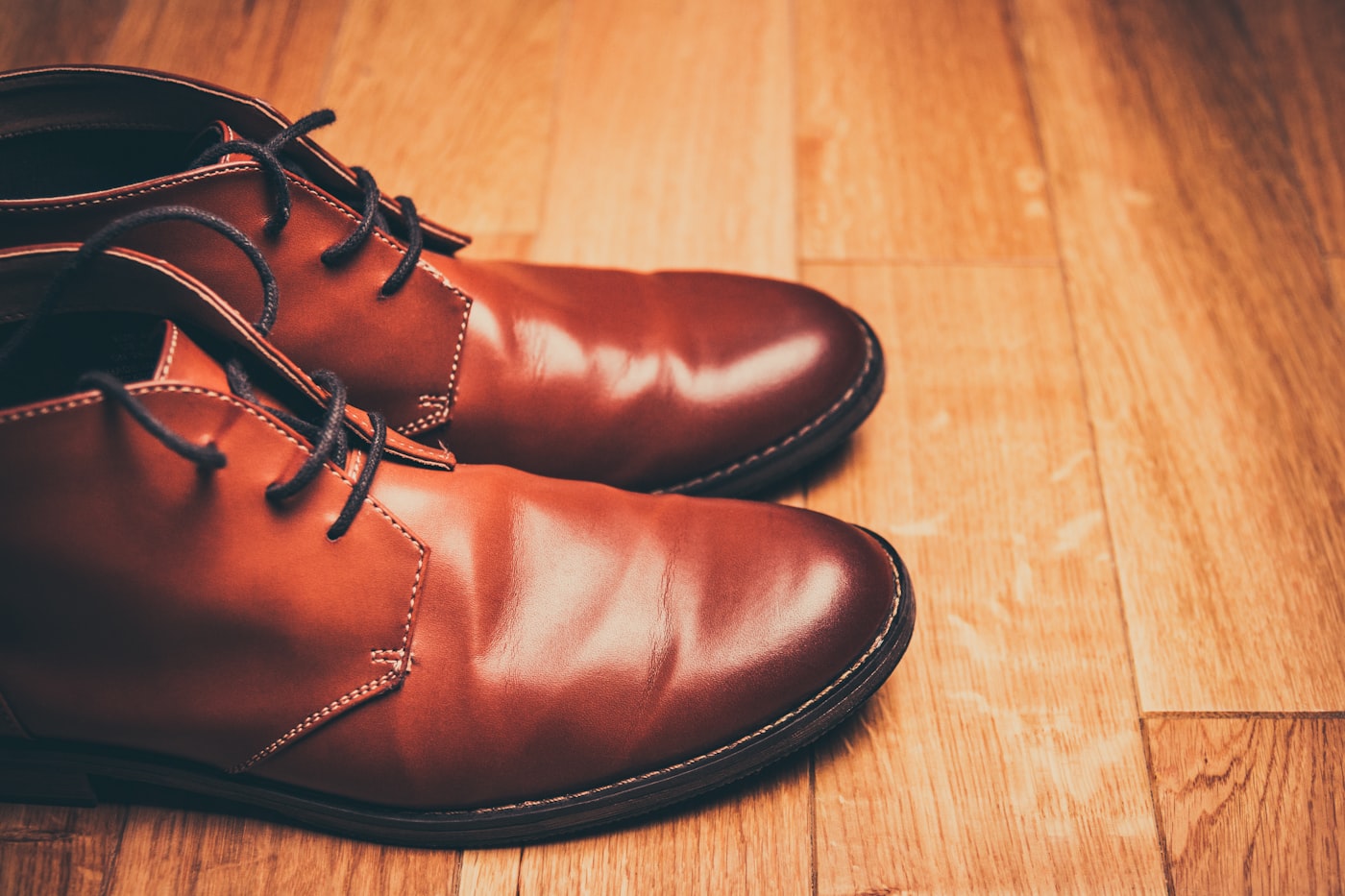 Worn leather shoes being repaired on a workbench